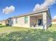 A view of the house and the patio area from the grassy backyard on a sunny day at 3105 Sangria St, Kissimmee, FL 34744