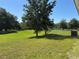 Sprawling green backyard with mature trees and a view of the water at 3105 Sangria St, Kissimmee, FL 34744
