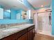 Bathroom with double sink vanity with granite countertop and a large updated walk-in shower at 3105 Sangria St, Kissimmee, FL 34744