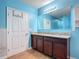 Bathroom with double sink vanity with granite countertop, updated mirror, and white doors at 3105 Sangria St, Kissimmee, FL 34744