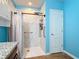 A walk-in shower features marble look tile, a black shower head, and white shower curtain at 3105 Sangria St, Kissimmee, FL 34744