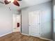 This bedroom features wood-look tile flooring and a ceiling fan with wood-look blades at 3105 Sangria St, Kissimmee, FL 34744