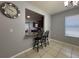 Bright dining area features tile floors, a modern chandelier, and a pass-through to the kitchen at 3105 Sangria St, Kissimmee, FL 34744