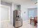Dining area with stainless steel refrigerator, table, chairs, and tile flooring at 3105 Sangria St, Kissimmee, FL 34744