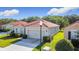 Well-kept home featuring tile roof, two-car garage, and mature landscaping for a serene view at 3105 Sangria St, Kissimmee, FL 34744