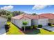 Well-maintained home boasts a tile roof, attached garage, and lush landscaping in a desirable neighborhood at 3105 Sangria St, Kissimmee, FL 34744