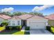 Charming single-story home features a well-maintained lawn, red roof and a two-car garage at 3105 Sangria St, Kissimmee, FL 34744