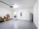 Large garage features painted flooring, a water heater, a laundry room, and a work area at 3105 Sangria St, Kissimmee, FL 34744