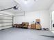 Spacious garage featuring epoxy floor, block walls, and an automatic door opener at 3105 Sangria St, Kissimmee, FL 34744