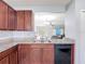 Kitchen with stainless steel sink, granite countertops, black appliances, and view into the living room at 3105 Sangria St, Kissimmee, FL 34744