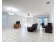Spacious living room featuring tile floors, barn doors, ceiling fan and natural light at 3105 Sangria St, Kissimmee, FL 34744