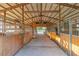 Spacious barn interior with individual stalls and good ventilation to ensure animal comfort and health at 3255 Tucker Ave, St Cloud, FL 34772