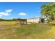 Exterior of the barn and the adjacent chicken coop and chicken at 3255 Tucker Ave, St Cloud, FL 34772