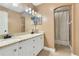 Bathroom with double sinks, granite countertops, and a shower with a neutral-toned curtain at 3255 Tucker Ave, St Cloud, FL 34772