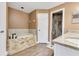 Elegant bathroom featuring a soaking tub with stone accents and a separate tiled shower at 3255 Tucker Ave, St Cloud, FL 34772