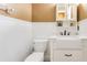 Charming half bathroom with white wainscoting, a farmhouse sink, and attractive fixtures at 3255 Tucker Ave, St Cloud, FL 34772