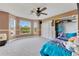 Bright bedroom with large windows, a ceiling fan, and ample closet space for storage at 3255 Tucker Ave, St Cloud, FL 34772