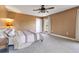 Comfortable bedroom with neutral decor, a ceiling fan, and ample natural light at 3255 Tucker Ave, St Cloud, FL 34772