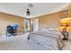 Comfortable bedroom with a ceiling fan, neutral walls, and ample natural light from the window at 3255 Tucker Ave, St Cloud, FL 34772