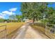 Long driveway leading to a beautiful home with well-maintained landscaping and mature trees at 3255 Tucker Ave, St Cloud, FL 34772