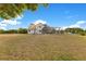 Charming two-story home featuring a large screened-in patio, nestled on a spacious lot with mature trees and sunny skies at 3255 Tucker Ave, St Cloud, FL 34772