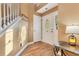 Inviting foyer with hardwood floors, white trim, and a decorative front door at 3255 Tucker Ave, St Cloud, FL 34772
