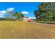 Expansive front yard showcasing a charming home with a covered porch and attached garage at 3255 Tucker Ave, St Cloud, FL 34772