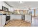 Modern kitchen with white cabinets, stainless steel appliances, and hardwood flooring at 3255 Tucker Ave, St Cloud, FL 34772