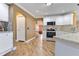 Another view of the kitchen with stainless steel appliances, granite countertops, and mosaic backsplash at 3255 Tucker Ave, St Cloud, FL 34772
