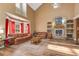 Large living room features stone fireplace, shelving, and plenty of natural light at 3255 Tucker Ave, St Cloud, FL 34772