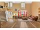 Open-concept living room with high ceilings, large windows, and a staircase at 3255 Tucker Ave, St Cloud, FL 34772