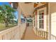 Inviting front porch with stone accents, hanging plants, and a charming American flag display at 3255 Tucker Ave, St Cloud, FL 34772