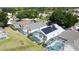 Aerial view of homes each featuring pools with screened enclosures, as well as solar panels on one roof at 334 Grosvenor Loop, Davenport, FL 33897