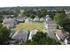 Community aerial view showcasing residences with screened-in pools surrounding a grassy common area at 334 Grosvenor Loop, Davenport, FL 33897
