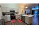 Bright kitchen featuring stainless steel appliances, ample counter space, and stylish cabinetry at 334 Grosvenor Loop, Davenport, FL 33897