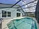 Sparkling pool area, fully screened, offering a private oasis connected to the home's outdoor living space at 334 Grosvenor Loop, Davenport, FL 33897