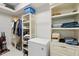 Organized closet with ample storage space, shelving, and a white freezer at 3421 Capland Ave, Clermont, FL 34711