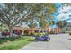 Charming clubhouse exterior, framed by palm trees and well-maintained landscaping, offering a welcoming community space at 3421 Capland Ave, Clermont, FL 34711