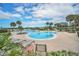 Community pool with surrounding lounge chairs and lush landscaping, offering a serene and relaxing atmosphere at 3421 Capland Ave, Clermont, FL 34711