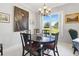 Formal dining area featuring a round table and classic decor under a decorative chandelier at 3421 Capland Ave, Clermont, FL 34711