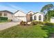 Beautiful one-story home features a paver driveway and meticulously landscaped front yard at 3421 Capland Ave, Clermont, FL 34711