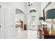 Foyer with tile floor, arched entryways, and a view of the bedroom through an open door at 3421 Capland Ave, Clermont, FL 34711