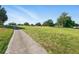 Scenic golf course view featuring lush green fairway and blue skies, showcasing the community's recreational amenities at 3421 Capland Ave, Clermont, FL 34711