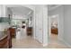 Open hallway showcasing tile flooring, neutral paint, and views into the living room and bedroom at 3421 Capland Ave, Clermont, FL 34711
