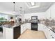 Open-concept kitchen featuring granite countertops, tile backsplash, and modern appliances at 3421 Capland Ave, Clermont, FL 34711