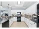 Bright kitchen features granite countertops, tile backsplash, and stainless appliances at 3421 Capland Ave, Clermont, FL 34711