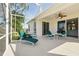 Outdoor screened lanai featuring comfortable lounge chairs, a ceiling fan, and access to the interior through sliding glass doors at 3421 Capland Ave, Clermont, FL 34711