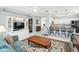 Bright living room with modern built-ins, a ceiling fan, and a view into the kitchen at 3421 Capland Ave, Clermont, FL 34711