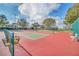 Vibrant pickleball court on a sunny day, complete with nets, benches, and equipment at 3421 Capland Ave, Clermont, FL 34711