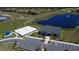 Aerial view showcases a pond, parking lot, beach volleyball court, and surrounding golf course at 345 Ocean Course Ave, Davenport, FL 33896